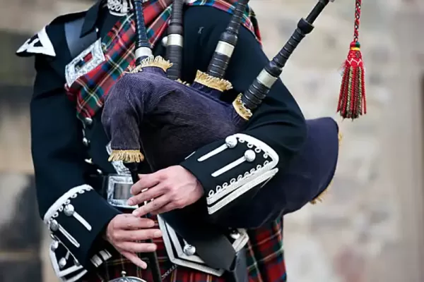 Playing Bagpiper in the Funeral by Fry Bros Funerals.