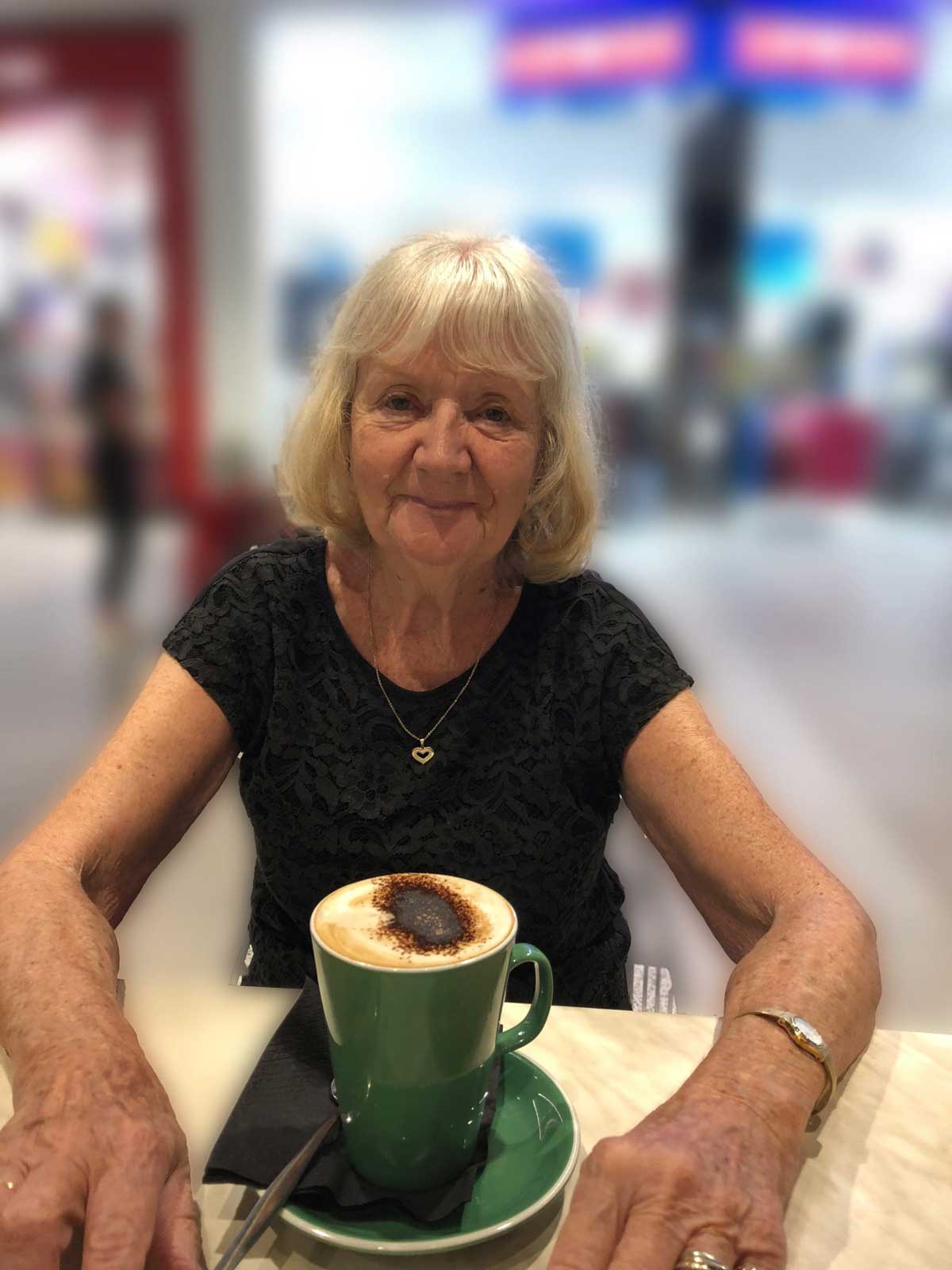 Woman sitting at table with coffee cup